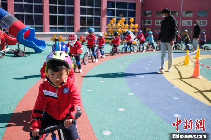 圖為拉薩市實(shí)驗(yàn)幼兒園孩子們?cè)诮叹毜闹笇?dǎo)下練習(xí)滑步車。　何蓬磊 攝