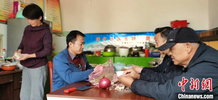 圖為扶貧路上“臨時一家人”準(zhǔn)備午餐?！∥航ㄜ?攝