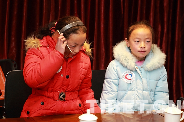 圖為澤旺卓瑪與志愿者阿姨通電話。攝影：陳衛(wèi)國(guó)