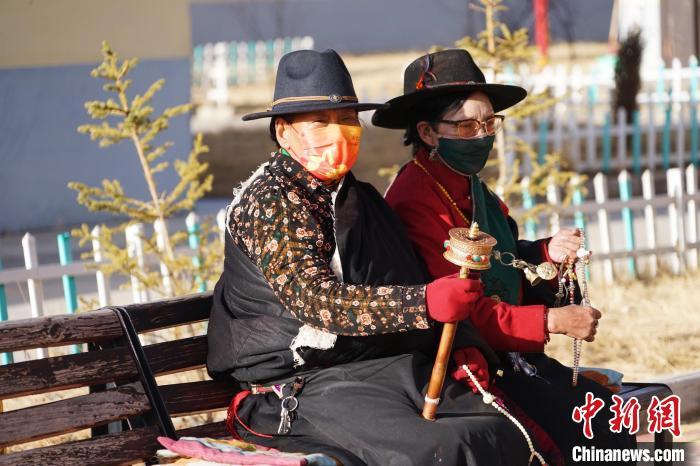 圖為敬老院老人在院內(nèi)曬太陽(yáng)轉(zhuǎn)經(jīng)桶。　馬銘言 攝