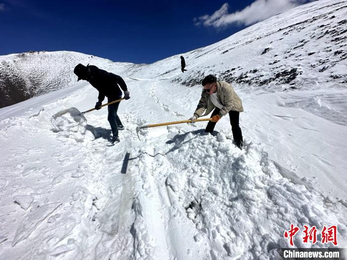 圖為生態(tài)管護人員在巡護道路上清雪?！《“瓦_杰 攝